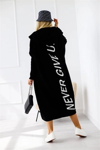 Detail of the white 'NEVER GIVE UP' artistic print on the back of a black hooded cardigan
