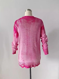 Distressed pink gradient knit sweater featuring tattered hem and oversized casual fit