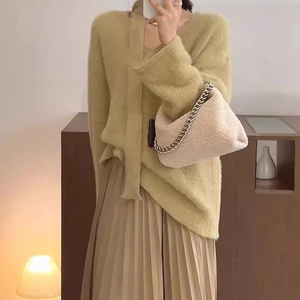 Chic yellow knit cardigan set and beige pleated skirt with stylish faux fur shoulder bag