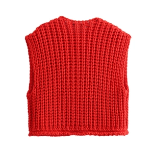 Close-up of vibrant red sleeveless knit vest with thick ribbed texture and v-neck design