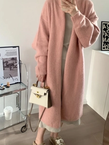Close-up of pink oversized knit cardigan featuring fuzzy texture and drop shoulder design