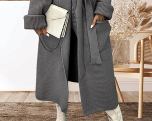 Detail of grey long knit cardigan featuring vertical ribbed texture and large side pockets