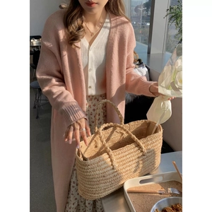 Detail of pink long-sleeved knitted cardigan with soft texture and V-neck styling