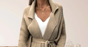 Close-up of khaki ribbed knit cardigan with elegant waist belt and wide lapel collar