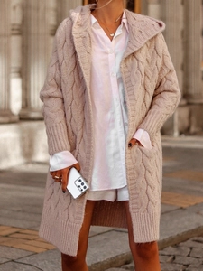 Close-up of cable-knit texture and hood detail on warm pink long knitted cardigan