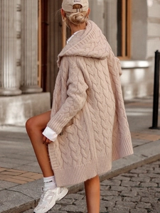 Detailed view of chunky cable knit texture on an oversized hooded long cardigan
