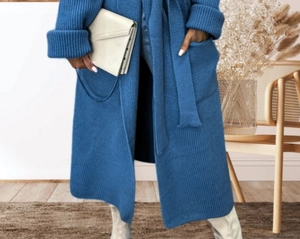 Detail of navy knit cardigan featuring vertical ribbed texture, large pockets and waist belt