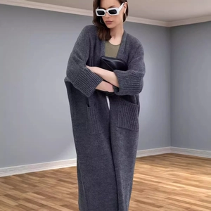 Women's oversized long knit cardigan sweater in dark charcoal grey with front pockets