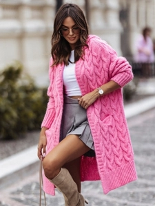 Close-up of pink cable knit cardigan with chunky texture and detailed hoodie design