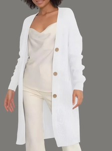 Detail of white long knit cardigan featuring brown round buttons and smooth texture