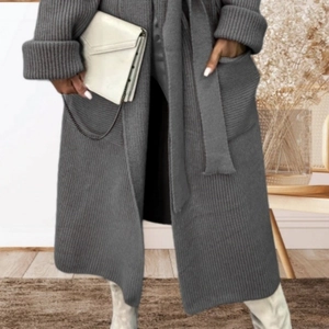 Long grey knit cardigan with belt and pockets for women in a cozy home setting