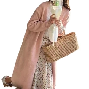 Pink long knit cardigan with V-neck for women styled with a floral maxi dress