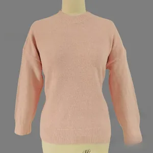 Close-up of pink knit sweater featuring ribbed cuffs and soft texture detail