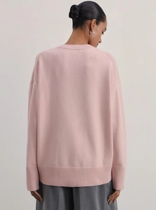 Oversized pastel pink knit sweater featuring ribbed cuffs and loose drop shoulder design