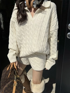 Detail of soft cream white cable knit sweater texture and v-neck collar design
