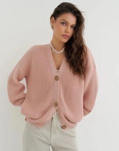Close-up of pink oversized knit cardigan featuring large round buttons and V-neckline