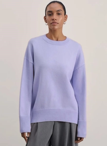 Detail of lavender crewneck knit sweater with ribbed cuffs and loose drop shoulder design
