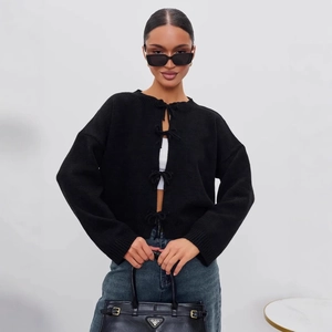 Chic black knitted cardigan with four front bow ties for a stylish casual autumn look