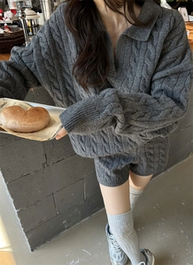 Close-up of gray cable knit sweater set featuring a V-neck collar and matching shorts