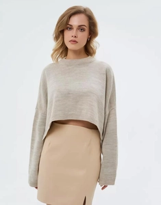 Detail of oatmeal cropped knit sweater featuring drop shoulder and soft texture fabric