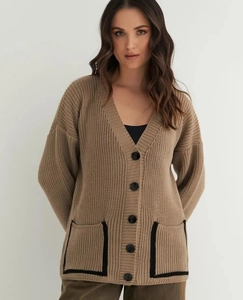 Detail of V-neck knit cardigan with contrast pockets and large black buttons