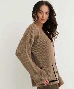Detailed view of taupe knit cardigan with V-neck, black buttons and contrast pocket trim