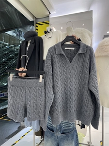 Detail view of dark grey chunky knit cable texture on v-neck sweater and shorts set