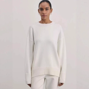 Women's cream white crewneck knit sweater with loose drop shoulders and ribbed cuffs