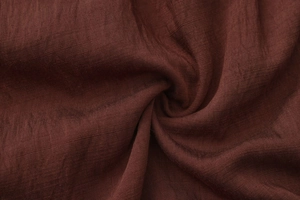 Detailed macro shot of the premium dark brown linen fabric showing texture and weave