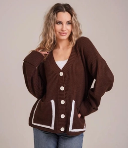 Detail view of V-neck knitted cardigan with contrast pocket trim and large white buttons