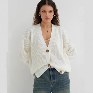 Minimalist cream white chunky knit cardigan with V-neckline and large wooden buttons