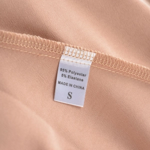 Detail view of garment care label showing 95% polyester and 5% elastane material content