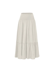 Detail of high waist smocked elastic waistband on off-white tiered A-line maxi skirt