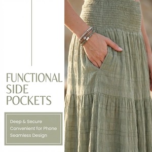 Detail showing the practical side pockets and elastic high waist of the sage green maxi skirt