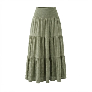 Macro detail of the tiered sage green maxi skirt showing textured pleated fabric layers