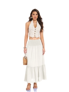 Detail of high waisted smocked elastic waistband on a white A-line maxi skirt