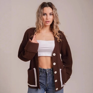Brown oversized V-neck knit cardigan with contrast trim and large white buttons