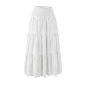 Detail of white tiered maxi skirt featuring elastic smocked high waist and textured fabric