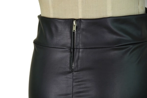 Detail view of high waisted matte faux leather skirt featuring a silver metal zipper back