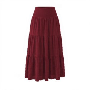 Detailed close-up of smocked high waist and textured fabric on burgundy tiered maxi skirt