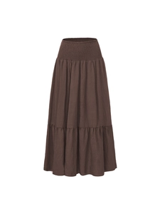 Detail view of the smocked elastic high waist and breathable fabric texture on long skirt