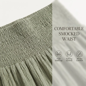 Detail of smocked elastic waistband on sage green long skirt with high elasticity