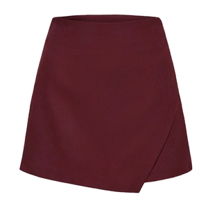 Detail view of burgundy asymmetrical wrap skort in premium faux suede with zipper closure