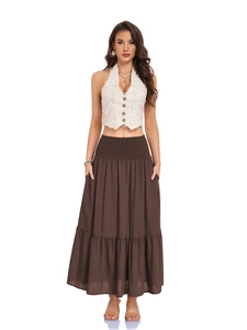 Detail of high waisted smocked elastic waistband and side pockets on a brown maxi skirt