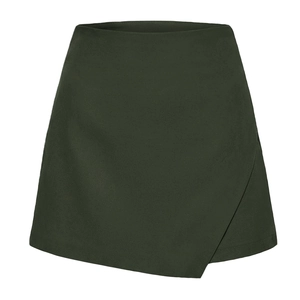 Front detail of dark green asymmetrical skort with high waist A-line wrap design