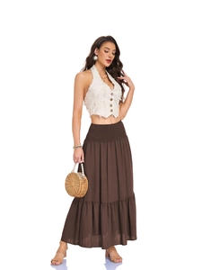 Detail of high waisted tiered maxi skirt with elastic smocked waist and side pockets