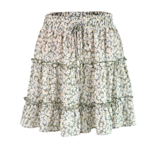 Detail of sage green floral mini skirt featuring elastic waist and ruffled daisy tiers
