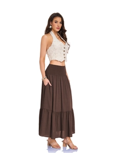 Detail of high waist smocked elastic waistband on a long tiered brown A-line skirt