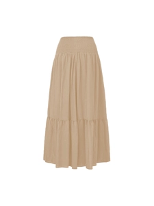 Close-up of high-waist smocked elastic band and layered ruffle hem on beige A-line skirt