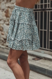 Detail of high waist floral mini skirt with triple-layered ruffles and drawstring waist